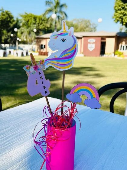 Our custom table centerpieces for the unicorn party included unicorn cutouts and rainbows, perfectly matching the overall theme.