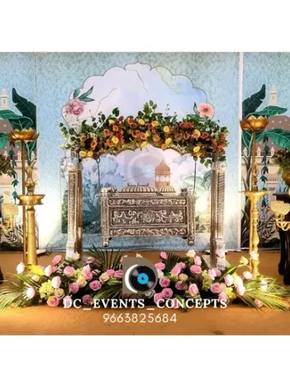 A full view of the traditional cradling ceremony decor, showcasing the elaborate setup with peacock motifs, brass lamps, and floral arrangements. This design is rich in cultural symbolism and elegance.