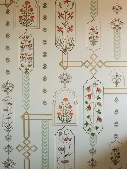 This wallpaper design is a direct homage to the intricate floral patterns found in Mughal architecture. Each motif is carefully placed within geometric frames, creating a sophisticated and rhythmic pattern that speaks of timeless elegance.