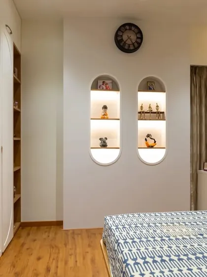 We add personalized touches to every room. These custom-built arched wall niches with integrated lighting provide the perfect display space for cherished decor items, adding character and warmth to the bedroom.