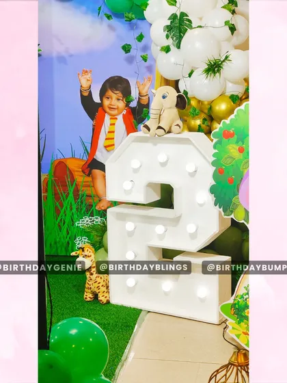 A detailed shot of the light-up number '2' next to a photo of the birthday boy on the backdrop, creating a perfect photo opportunity.