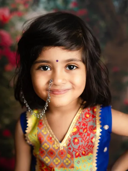 A beautiful close-up of our little Radha. The traditional nath (nose ring) and bindi complete the festive look perfectly.