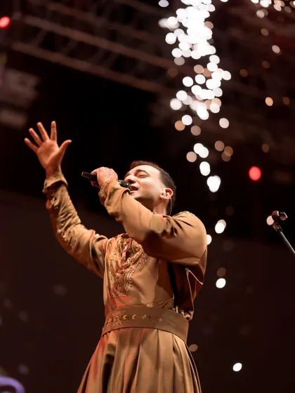 Singing a chant during a high-energy moment, with sparks flying in the background. These moments are about channeling a powerful, collective spiritual energy.
