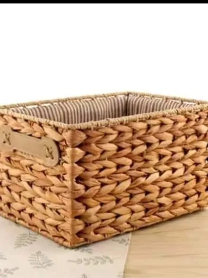 A sturdy, rectangular basket woven from water hyacinth with a leather-like handle detail. This versatile basket is ideal for organizing shelves, desktops, or for use as a small hamper.