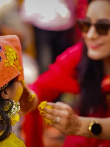 A little one getting in on the Haldi fun. The Powerpuff Girls handkerchief adds a cute and quirky detail to this candid moment.