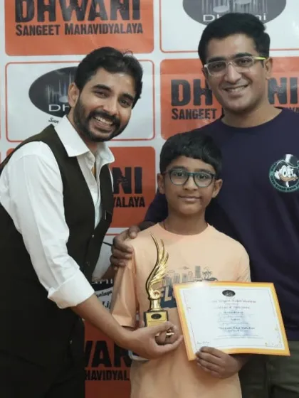 A student with his family and teacher, all celebrating his artistic success.
