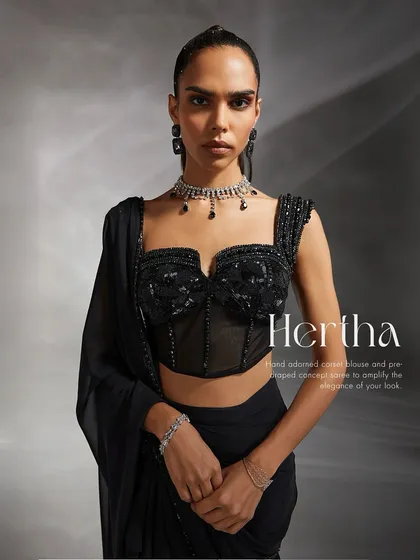 The Hertha set is subtle but fierce. I designed this piece with a hand-adorned corset blouse and a pre-draped concept saree to create a look of pure, amplified elegance.