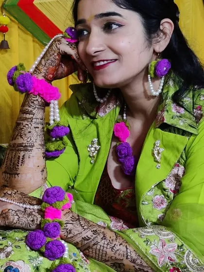 For the bride-to-be who wants something truly unique. I designed and created this custom crochet floral jewelry set for a mehndi ceremony. The set includes a maang tikka, earrings, and hathphool bracelets, all handmade with vibrant purple and pink yarn and detailed with pearls.