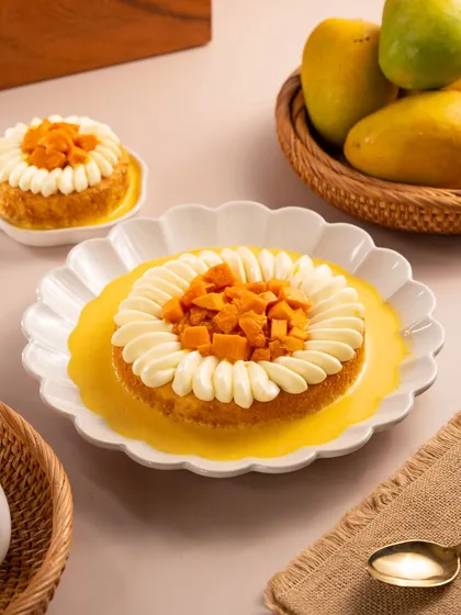 A mango tres leches style cake. The bright yellow of the mango puree and fresh fruit screams summer.