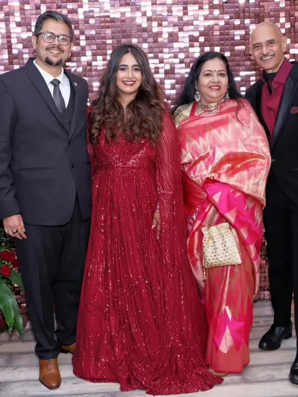 This bride chose a classic red gown for her reception. The makeup is glamorous with a defined eye and a matching red lip, while her hair is styled in soft, flowing waves.