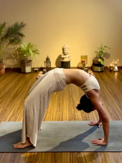 A still image of my Urdhva Dhanurasana (Wheel Pose) in the shala. This pose builds strength in the arms, legs, and spine while opening the chest.