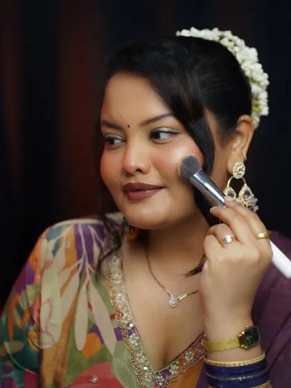 A shot of me applying blush, demonstrating a step from the festive glam tutorial.