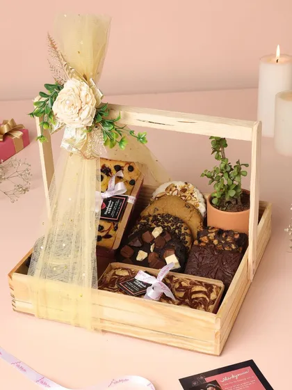 Gifting should feel special, and my festive hampers are designed to do just that. This wooden basket hamper is filled with my best-selling brownies, cookies, and a plant for a touch of green, perfect for Diwali or any celebration.