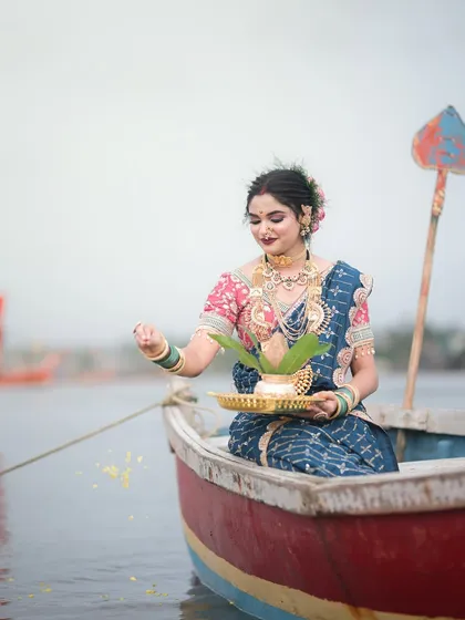 The ritual of offering flowers and coconut to the sea, a central part of the Narali Purnima festival.