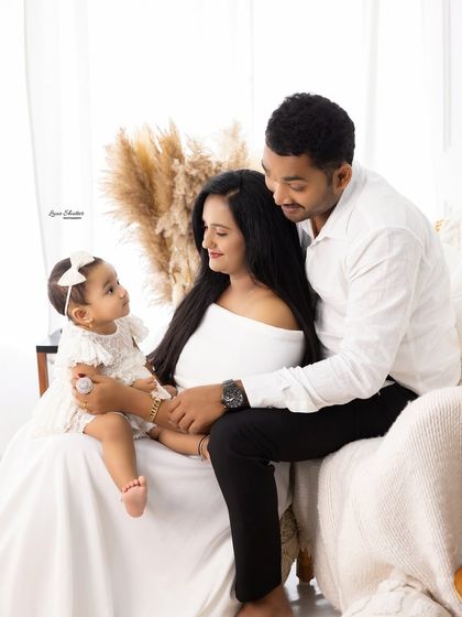 A sweet family moment on our studio's boho-style couch. The soft textures and warm tones create a cozy and inviting atmosphere for your family portraits.