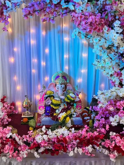Our cherry blossom theme is a favorite for its delicate and modern look. Here, we have created a beautiful arch with pink, white, and red artificial cherry blossoms, complemented by a soft white curtain backdrop with fairy lights for a magical glow.