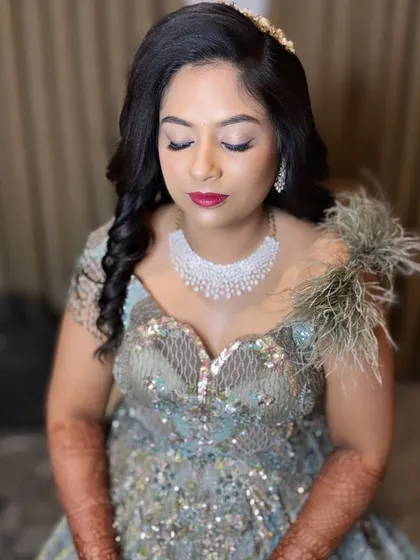 Too glam to give a damn. This reception makeup features shimmery eyes and a bold red lip, perfect for an evening celebration.