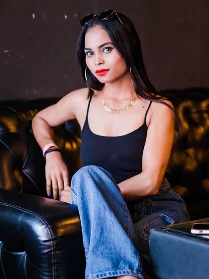 A guest posing on a leather couch.