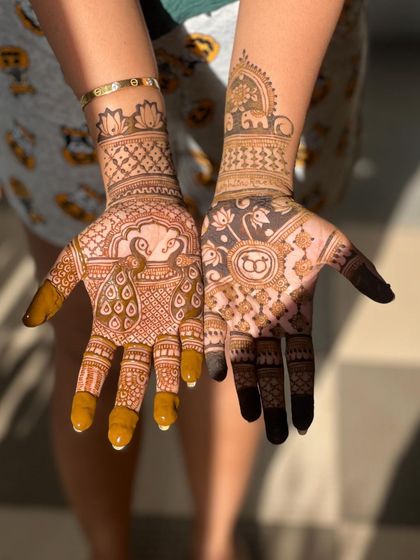 This engagement design features a peacock on one hand and a lotus with initials on the other. The mix of motifs makes the design unique and personal.