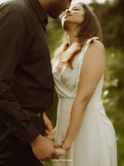 A duplicate of image 1, an intimate close-up that highlights the texture of the clothing and the bride's watch.