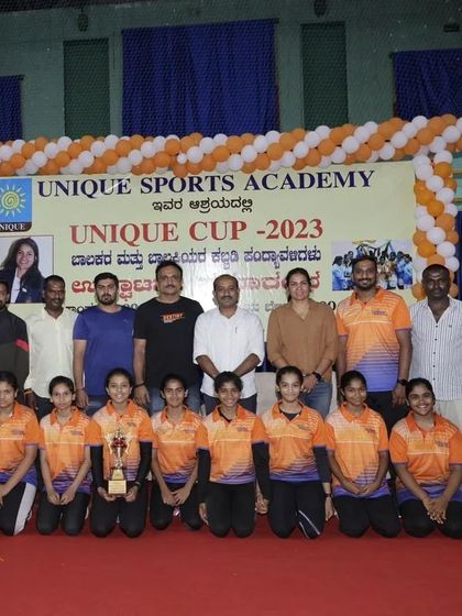 The runner-up girls' team from the Unique Cup 2023, showing their trophy and team spirit.