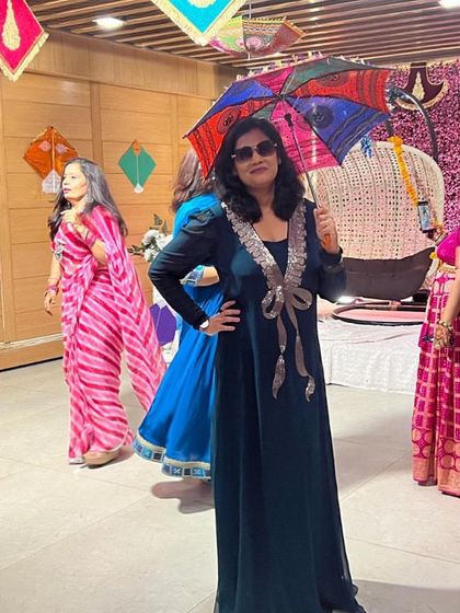 A client celebrating Teej in a beautiful dark green gown with an embellished bow.