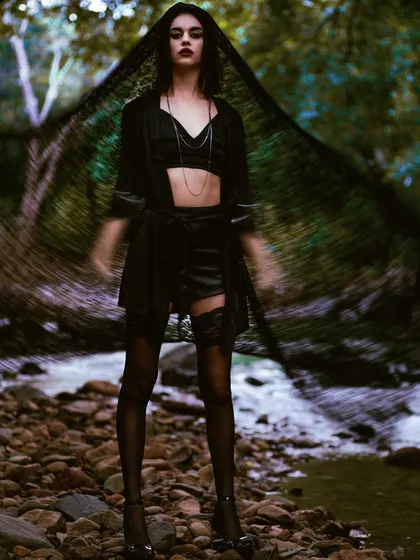 A moody, atmospheric shot from the Mind Magazine editorial. The use of a slow shutter speed and a black veil creates a ghostly, ethereal effect that is both haunting and beautiful.