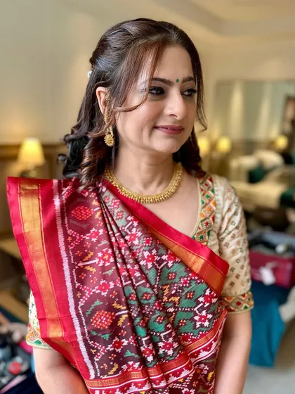 Traditional charm with a modern glow. This soft yet striking makeup enhances her natural beauty, perfect for the mother of the bride.