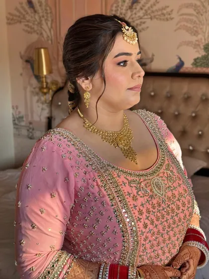 A side profile showing the clean, elegant hairstyle and the soft contour of her makeup. This is timeless beauty.