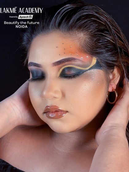 This image highlights the glossy lip and flawless skin that balance the dramatic eye makeup.