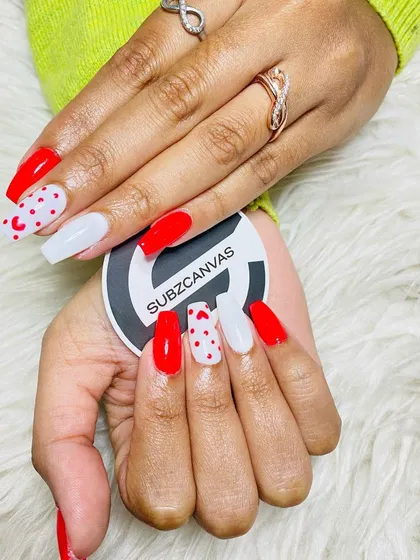 Get into the spirit of any occasion with themed nail art. This Valentine's set combines bold red, clean white, and playful heart patterns for a fun and festive look that’s perfect for celebrating.