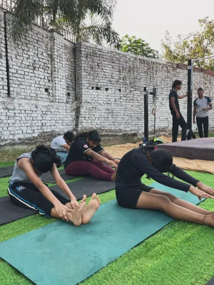 A powerful morning starts with stretching. Our members work on their forward folds, increasing hamstring flexibility and preparing their bodies for the workout ahead.