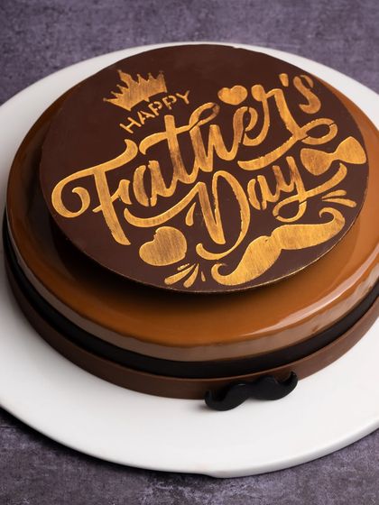 A special cake designed just for Father's Day. This coffee and chocolate creation has a rich, glossy finish and is topped with a custom "Happy Father's Day" chocolate plaque.