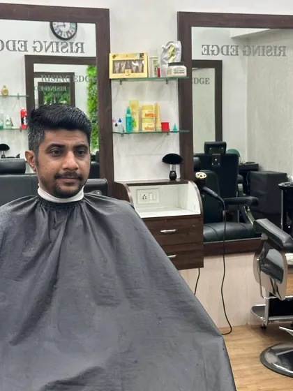 A satisfied client in the chair after his haircut. I always check to ensure the final look is exactly what you wanted.