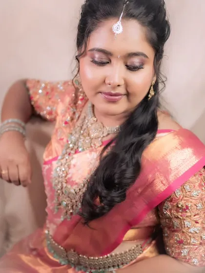 A graceful portrait of a bride at her reception. The soft lighting and elegant pose highlight the beauty of her makeup and outfit.