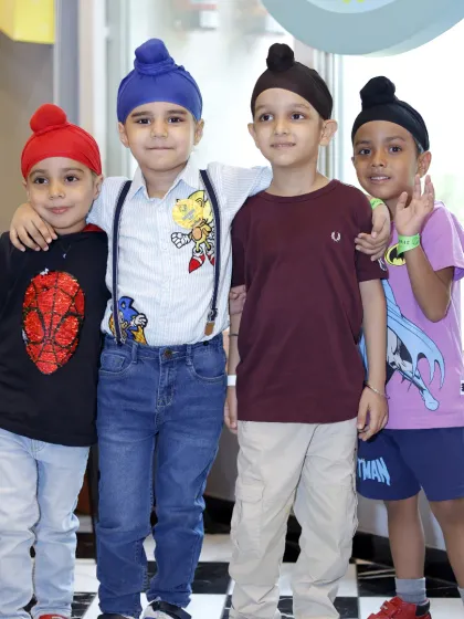 A group of four friends stands together, showcasing the fun and friendship found at Tingaland.