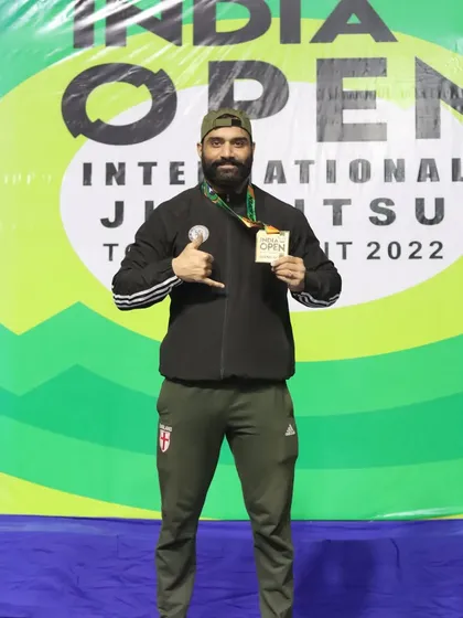 Posing with my medal at the India Open International Jiu-Jitsu Tournament in 2022. The goal is always to stay focused and compete.
