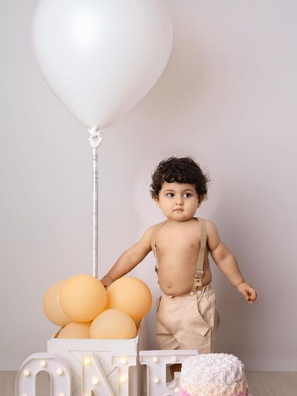 A portrait of the birthday boy before the smashing began, looking adorable next to his cake.