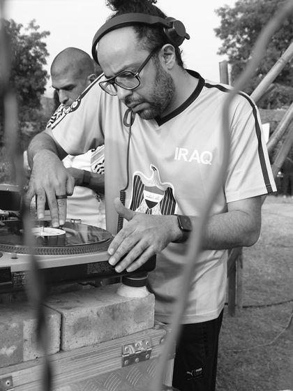 A detailed shot of me cueing up a record on the turntable during an outdoor sound system session. It's a raw, authentic way to experience music.