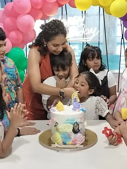 The best part of any birthday: the cake cutting ceremony. Here, friends and family gather around to celebrate a special 5th birthday, showing the happy, communal atmosphere we foster.