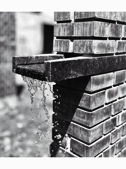 A close-up of a water spout detail at the Mandala Experience Center. This image highlights our focus on craftsmanship and the integration of functional elements, like gutters, into the architectural expression of the building.