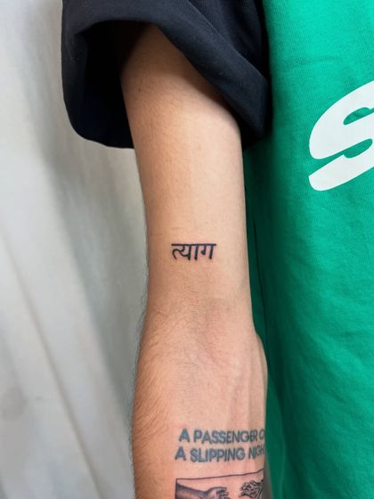 The word "Tyag," meaning sacrifice in Sanskrit, inked as part of a series of memorial tattoos. This simple yet profound piece honors the sacrifices made in a cherished relationship.