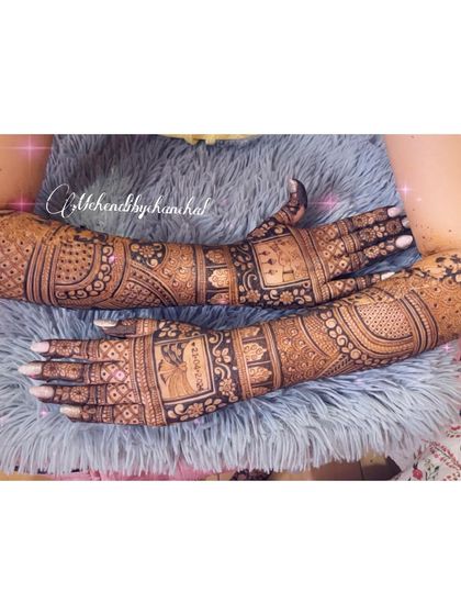 A full view of the arms, showing the complete design with portraits and patterns.