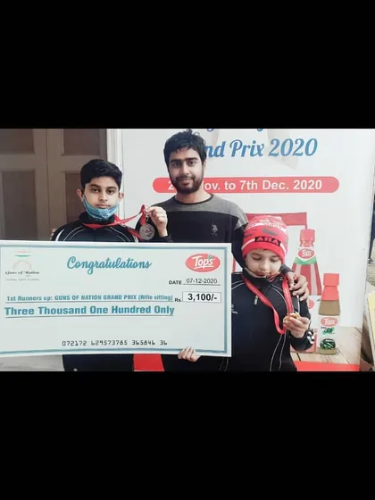 Two of our little champs with their coach and their prize winnings. We believe in celebrating every achievement, big or small.