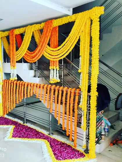 A staircase decorated with traditional marigold strings. This is a simple yet very effective way to bring the festive spirit inside the house for a Haldi or Pooja ceremony.