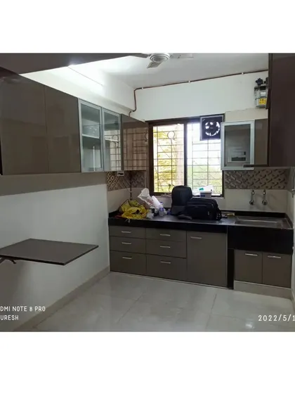 In this Kandivali kitchen, I installed a compact, wall-mounted breakfast table. It provides a convenient spot for a quick meal without taking up permanent space in the kitchen layout.