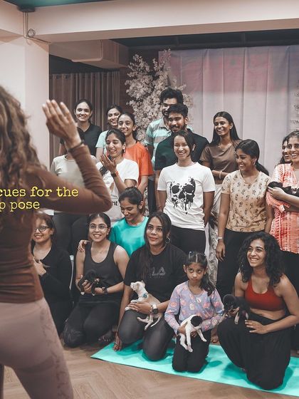 Our instructor cues the group for a photo, a happy crowd of people and puppies celebrating community and adoption.