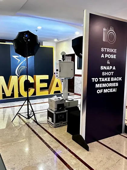 The complete photo booth station at the MCEA awards. The setup includes the booth, printer, and professional lighting, all in a compact footprint.