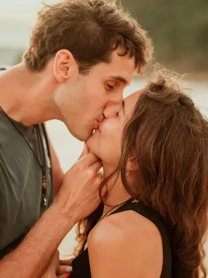 A close-up of a passionate kiss on a beautiful Bali beach. This photo captures the raw emotion and romance of a couple's connection in a stunning setting.