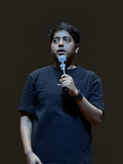 A classic stand-up shot of Aakash Gupta holding the mic during his show for Solstice at MIT Bengaluru.